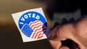 A voter holds an “I Voted” sticker on Election Day 2022 in Pennsylvania.