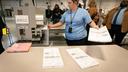 Philadelphia Election Clerk Lisa Gogel demonstrates a ballot scanner that will be used in the 2022 election in Pennsylvania.