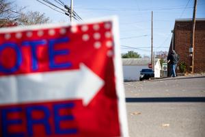 A sign urging people to "vote here" on Election Day 2022.