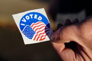 A voter holds an “I Voted” sticker Nov. 8, 2022, at Memorial Hall in Jim Thorpe Carbon County, Pennsylvania. (Matt Smith / For Spotlight PA)