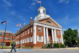 Bedford County's district attorney charged a man for firing a 12-gauge shotgun at civil rights marchers last August, striking one in the face.