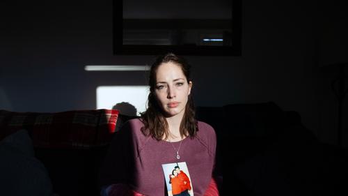 Amanda Pschirer sits for a portrait holding one of her favorite photos of her and brother, James Pschirer, at her home in McCandless on Thursday, Feb. 25, 2021.